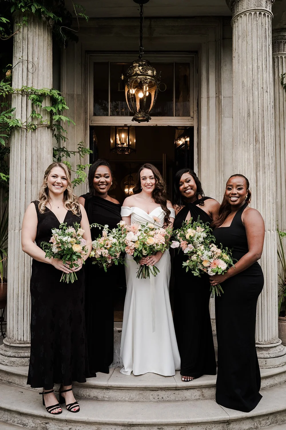 Chloe and her bridesmaids on the steps at Brunswick House in Vauxhall