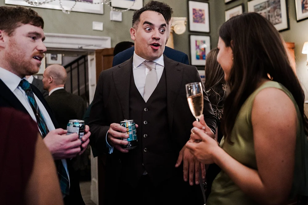 Guests with drinks in the hallway at Brunswick House