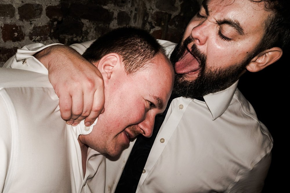 Black and white photograph of guests singing on the dance floor