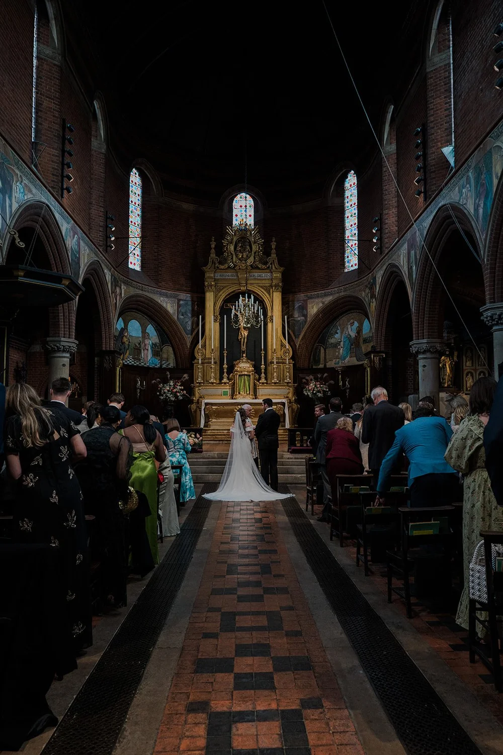 The nave and gilded reredos at St Mary&rsquo;s Bourne Street during the wedding ceremony