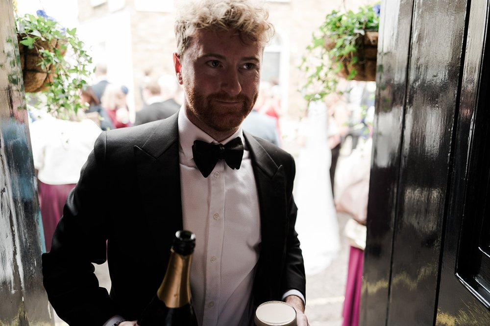 Jon carrying champagne through the drinks reception at the pub