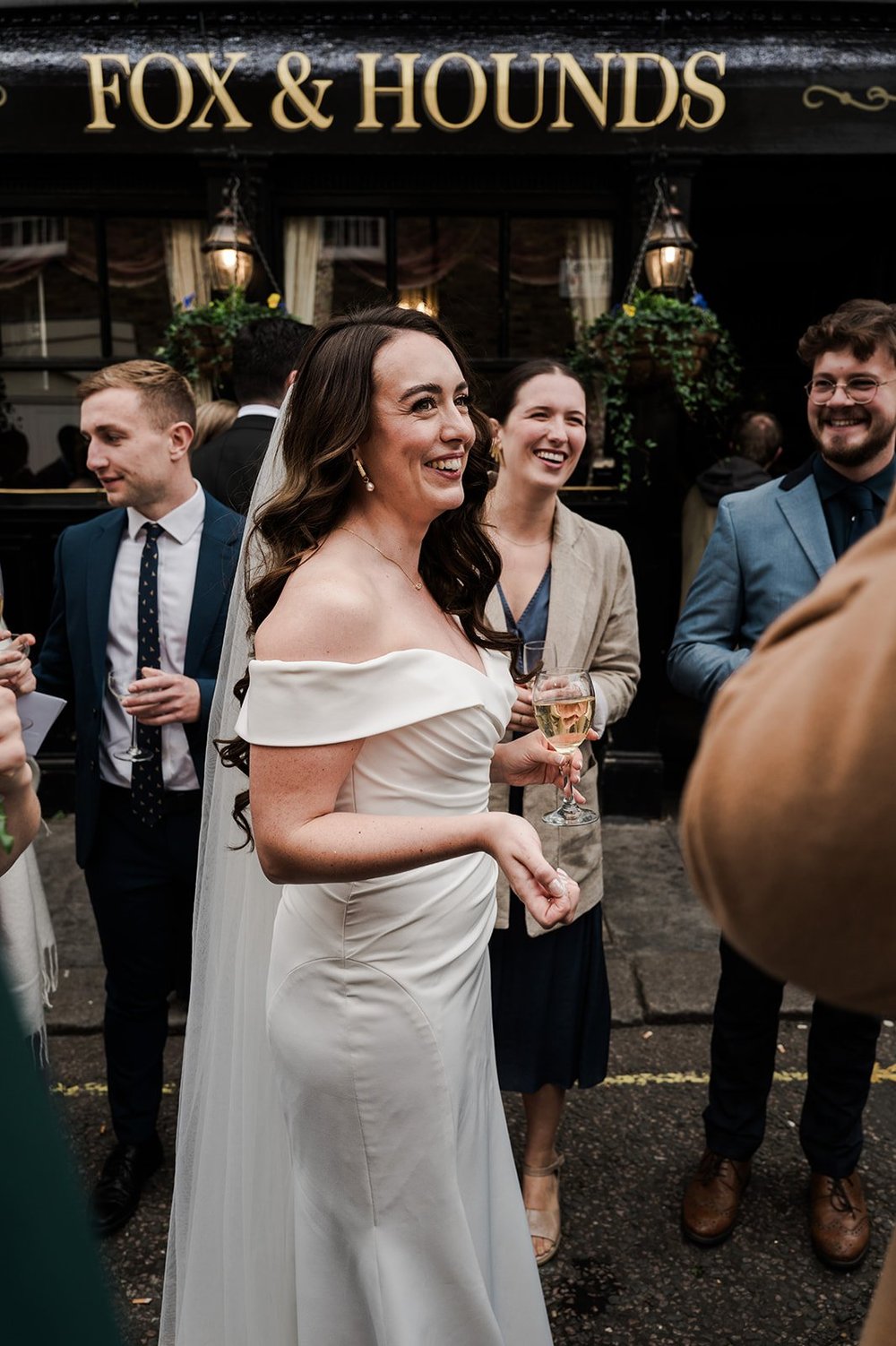 Chloe talking to guests outside the pub after the ceremony