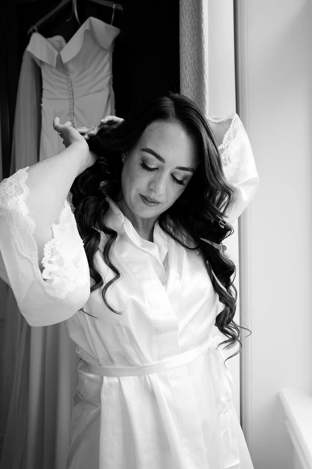 Black and white photograph of Chloe getting ready on her wedding morning