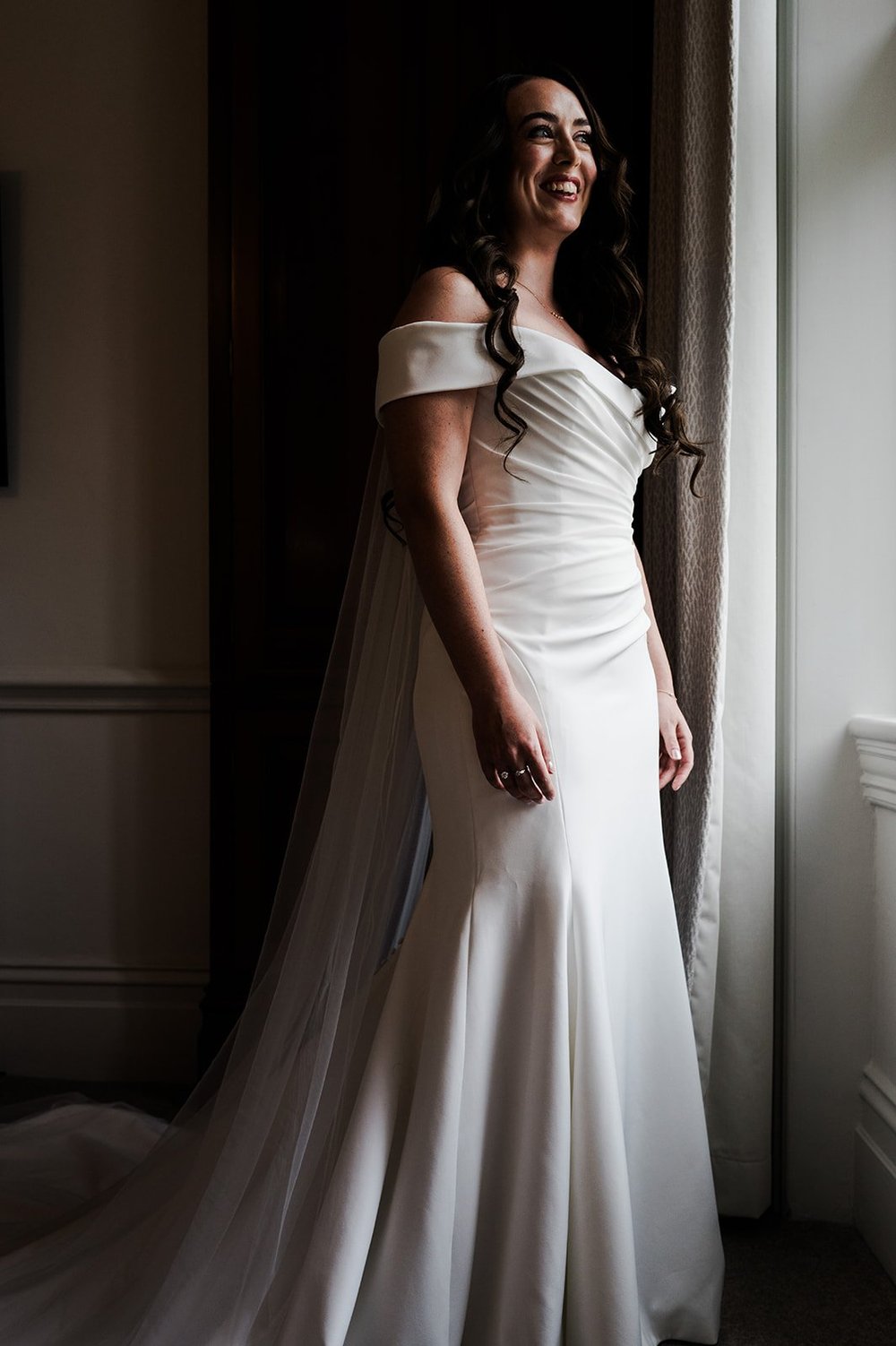 Chloe in her wedding dress in the doorway before leaving for the church