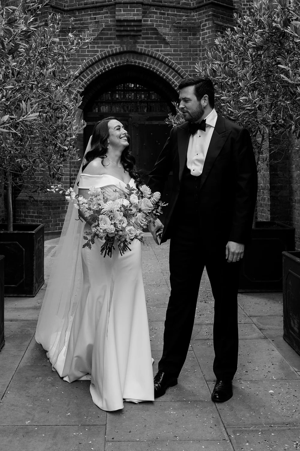 Chloe and Jon with her bouquet outside the church in Pimlico