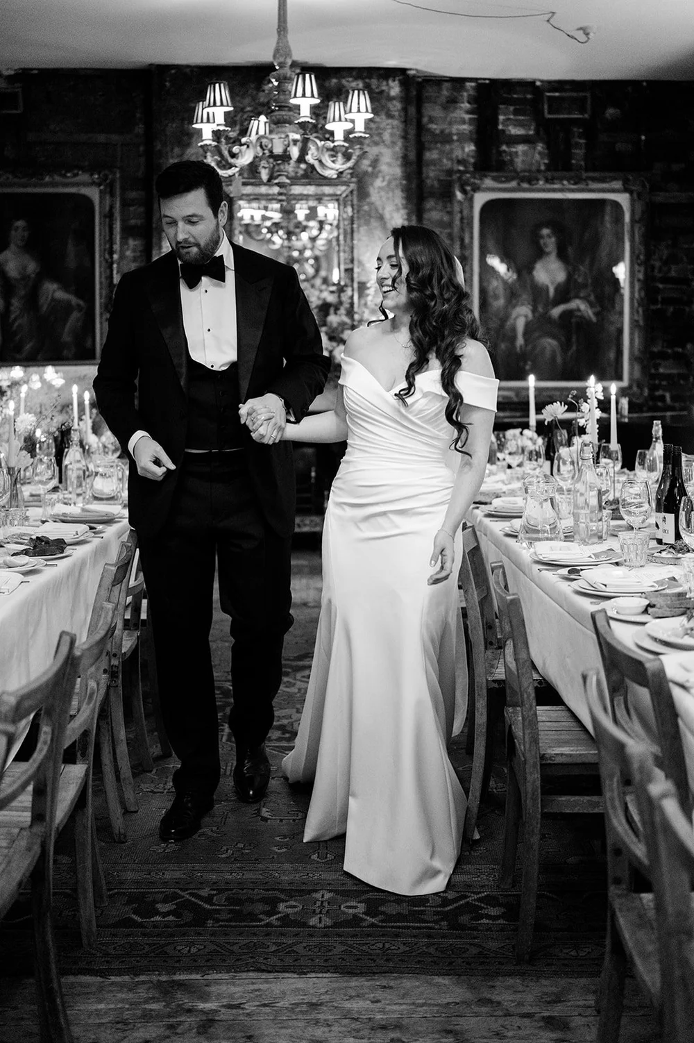 Black and white photograph of Chloe and Jon walking into dinner at Brunswick House