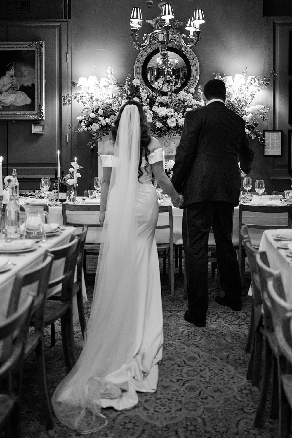 Black and white photograph of the dining room and mantelpiece flowers at Brunswick House
