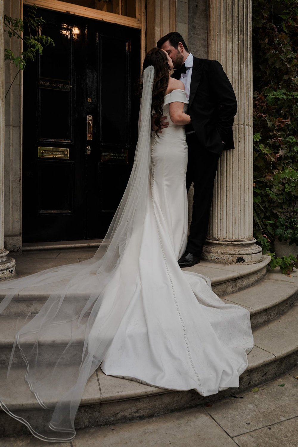 Chloe and Jon kissing in the doorway at Brunswick House in Vauxhall