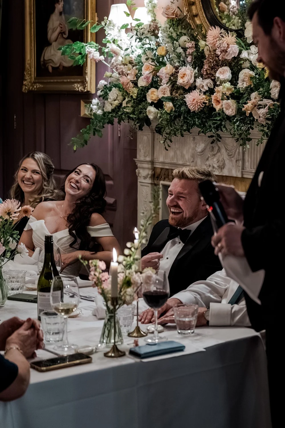 Chloe and Jon at the top table under the mantelpiece flowers