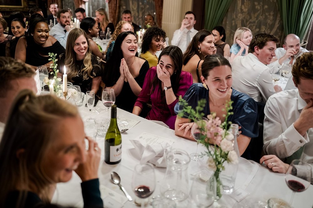 Guests along the table reacting to the speeches