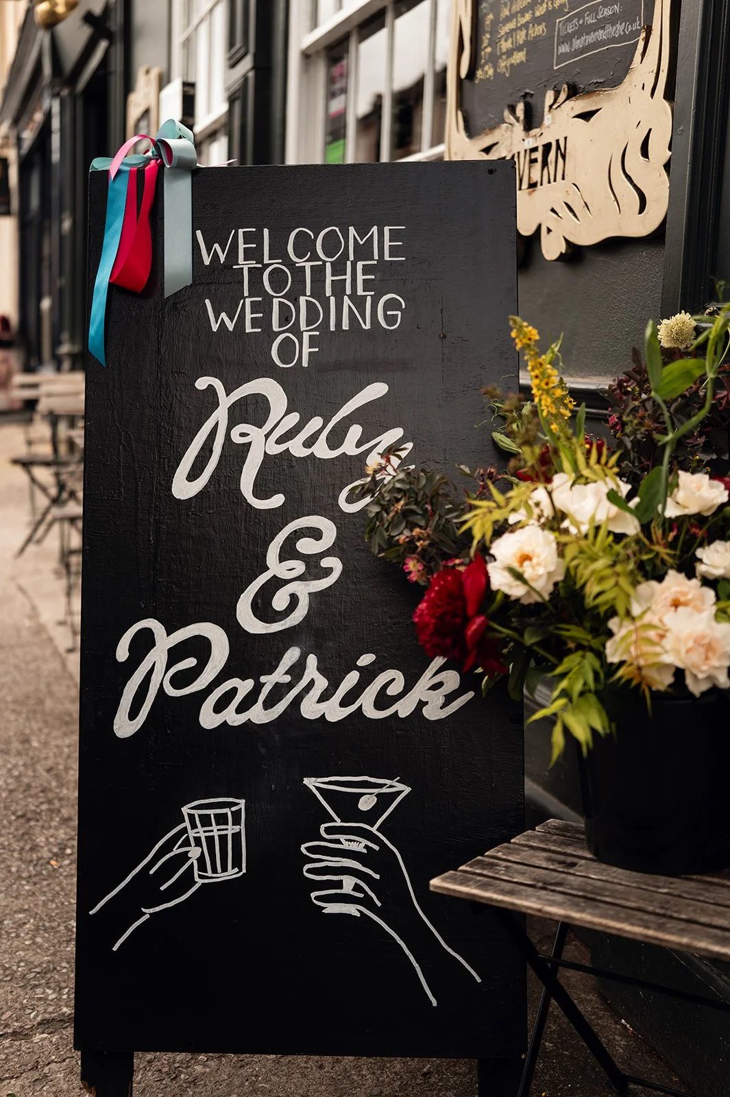 A chalkboard reading Welcome to the wedding of Ruby and Patrick at The Alma Tavern