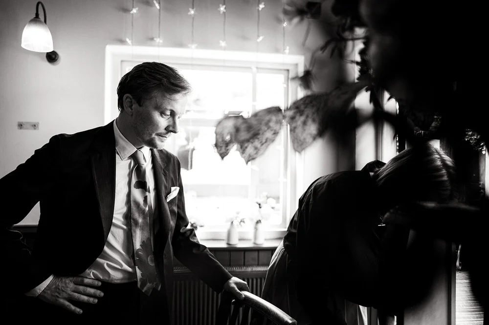 Black and white photograph of Patrick getting ready before the ceremony