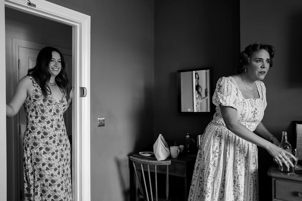 Black and white photograph of Ruby in the doorway before her wedding at The Alma Tavern