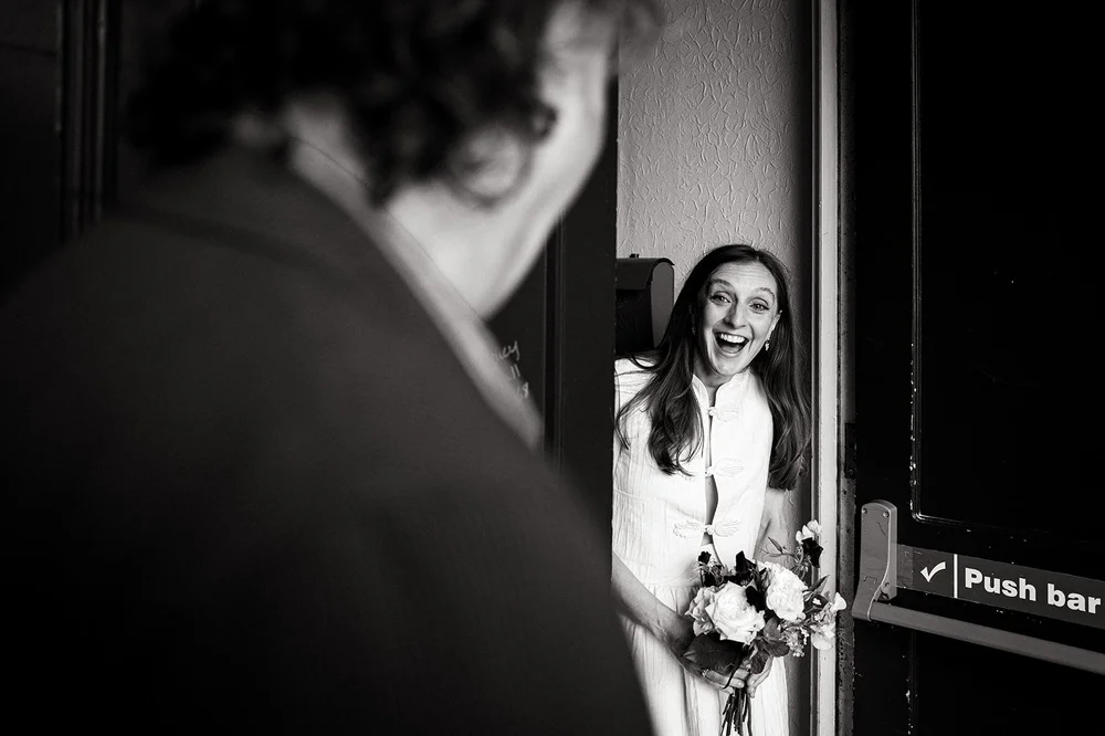 Black and white photograph of Ruby with her bouquet before the ceremony