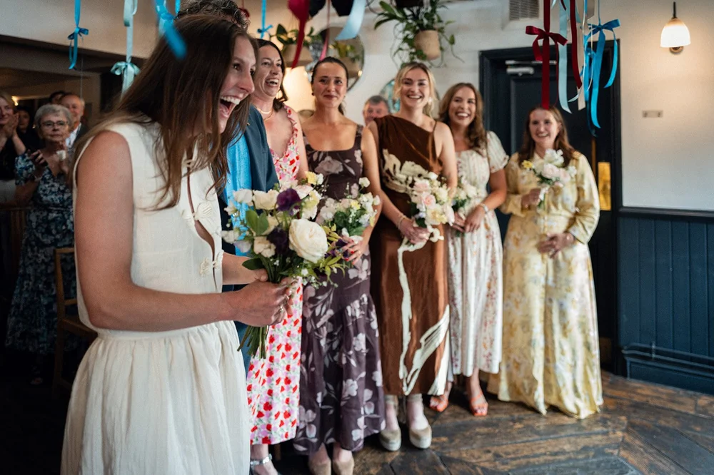 Ruby and her bridesmaids holding their bouquets at The Alma Tavern