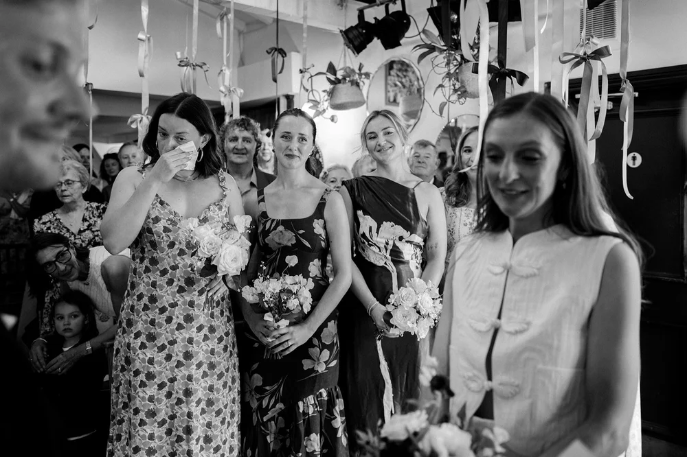 Black and white photograph of guests waiting for the ceremony to begin