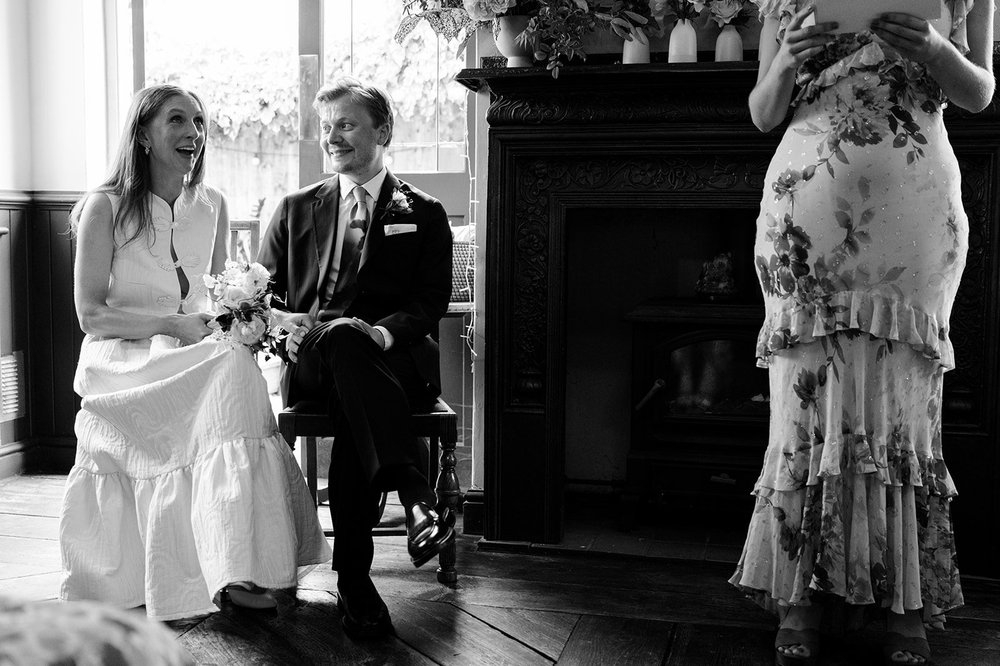 Guests seated closely together for the wedding ceremony at The Alma Tavern