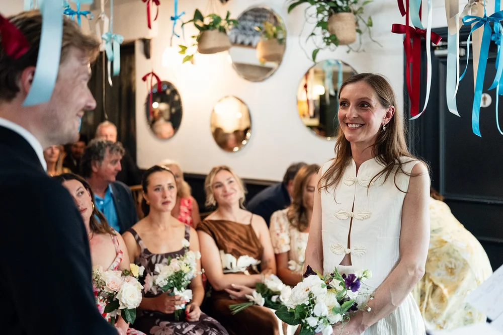 Family watching the wedding ceremony from the front row at The Alma Tavern