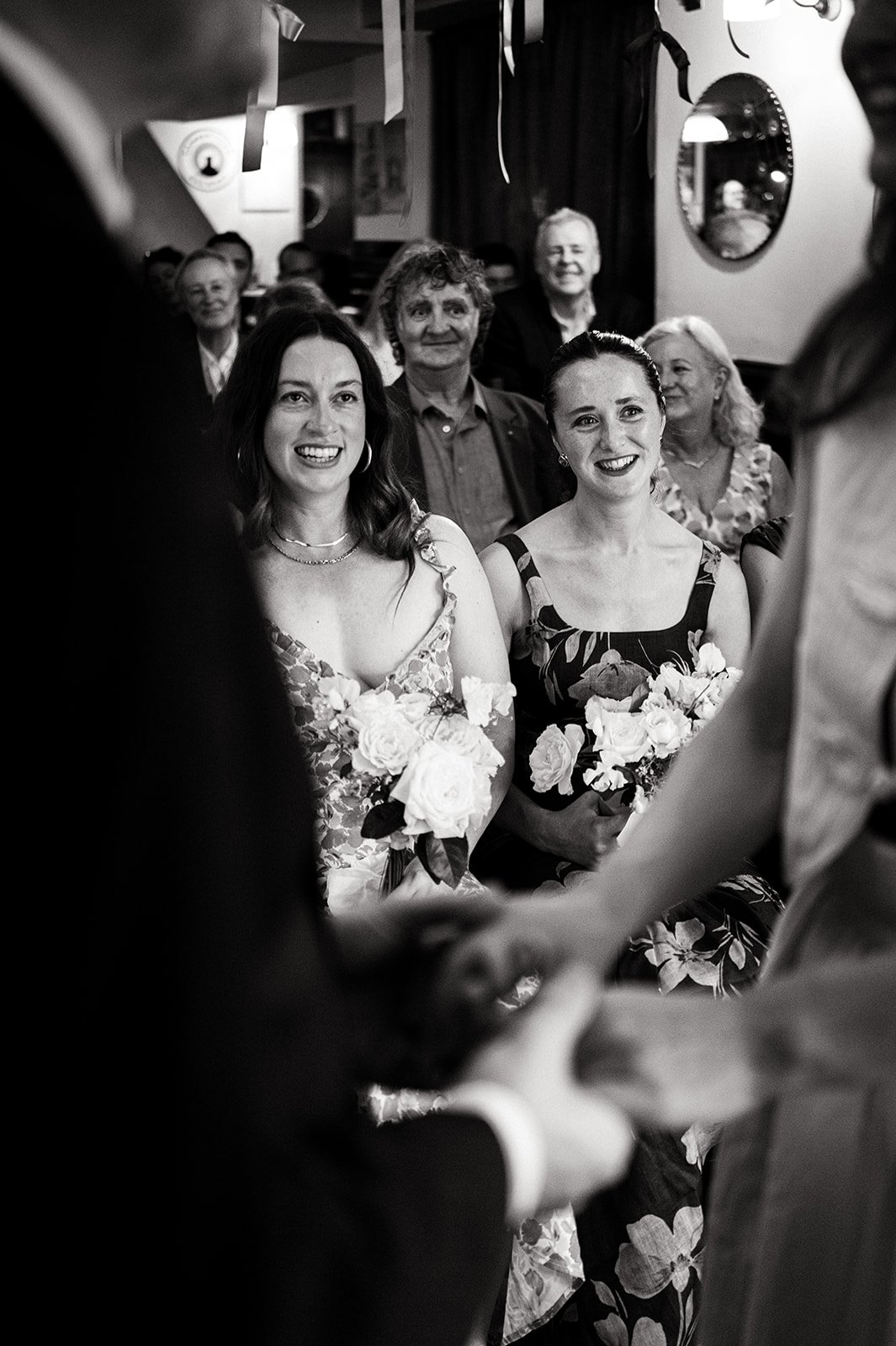 Guests cheering with their arms in the air as Patrick and Ruby are married