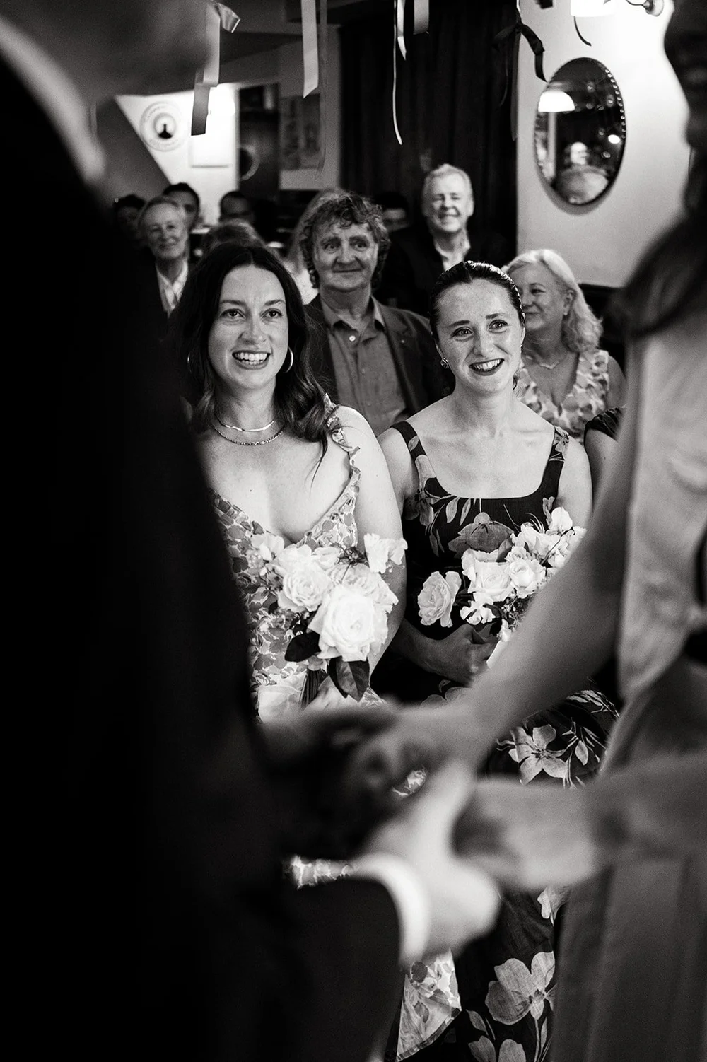 Guests cheering with their arms in the air as Patrick and Ruby are married
