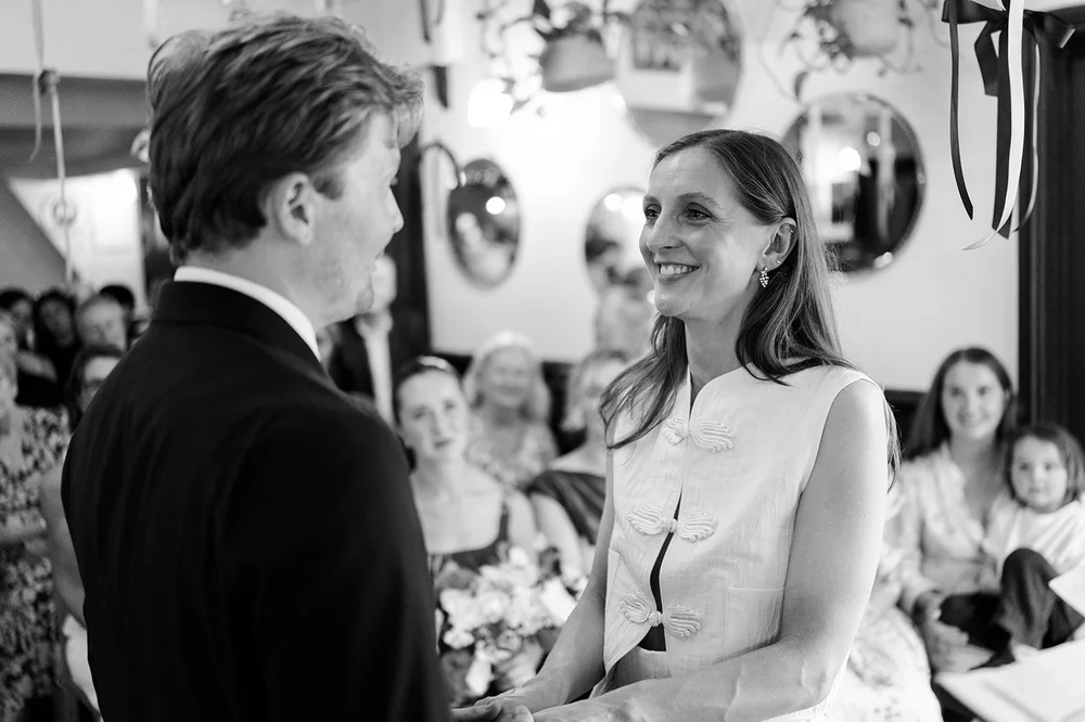 Black and white photograph of guests during the ceremony at The Alma Tavern