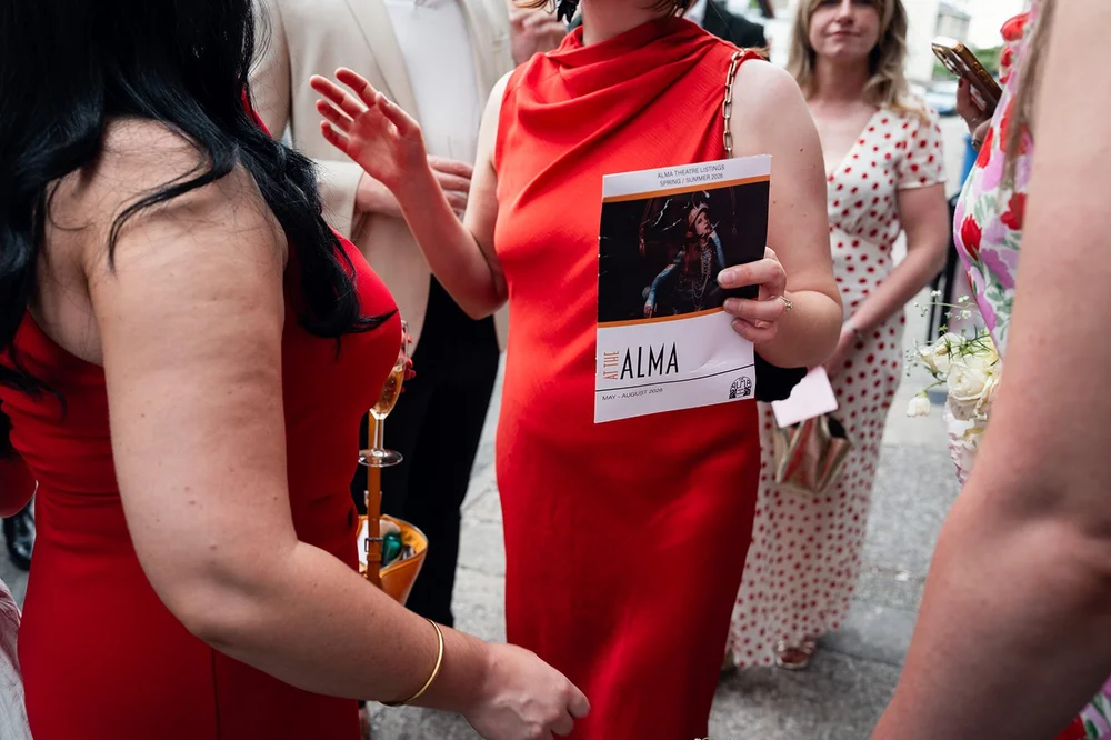 Guests laughing together over a glass of fizz at The Alma Tavern