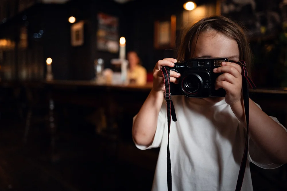 A guest photographing Patrick and Ruby on a camera