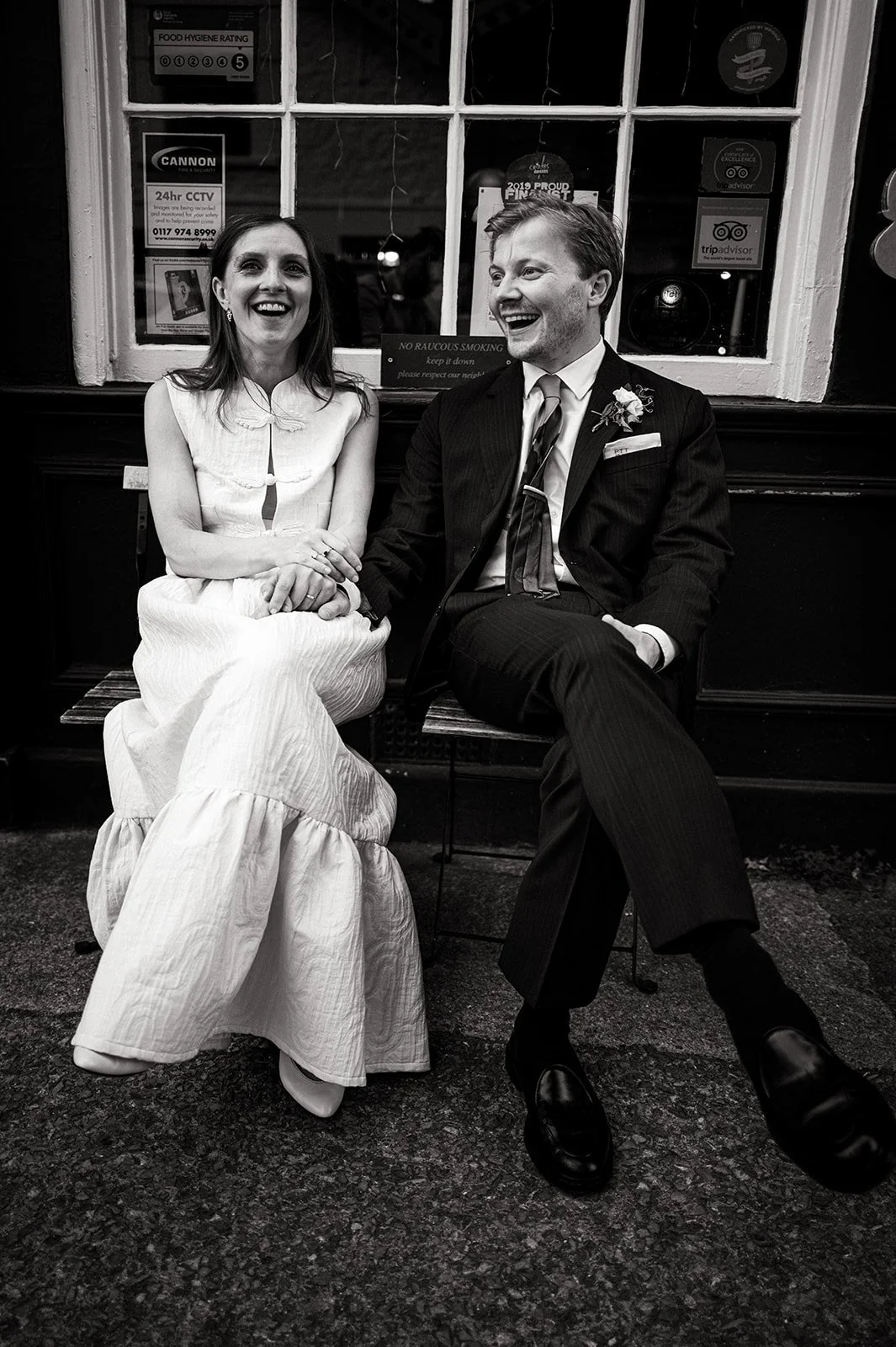 Patrick and Ruby sitting together on the bench outside The Alma Tavern