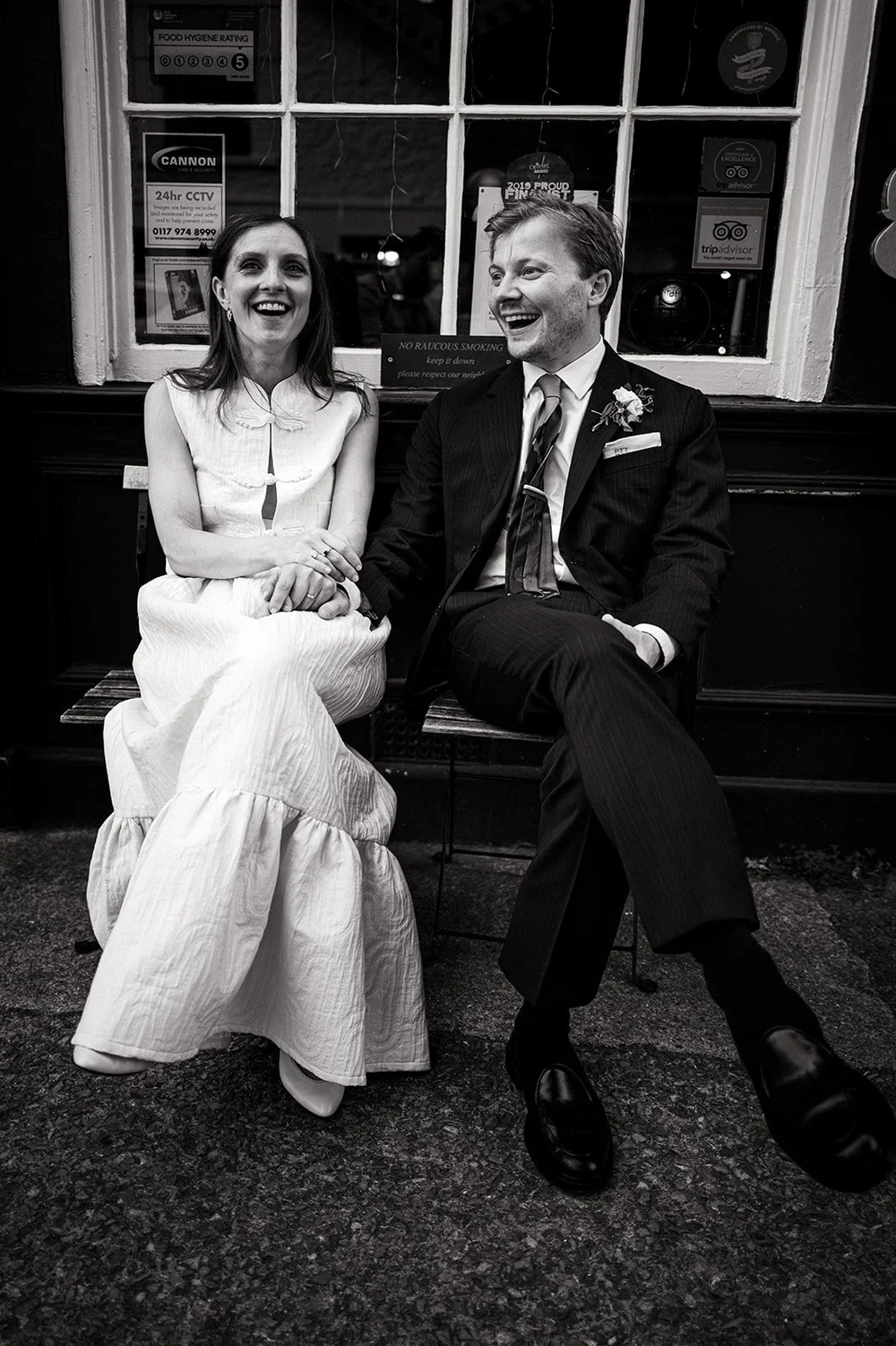 Patrick and Ruby sitting together on the bench outside The Alma Tavern
