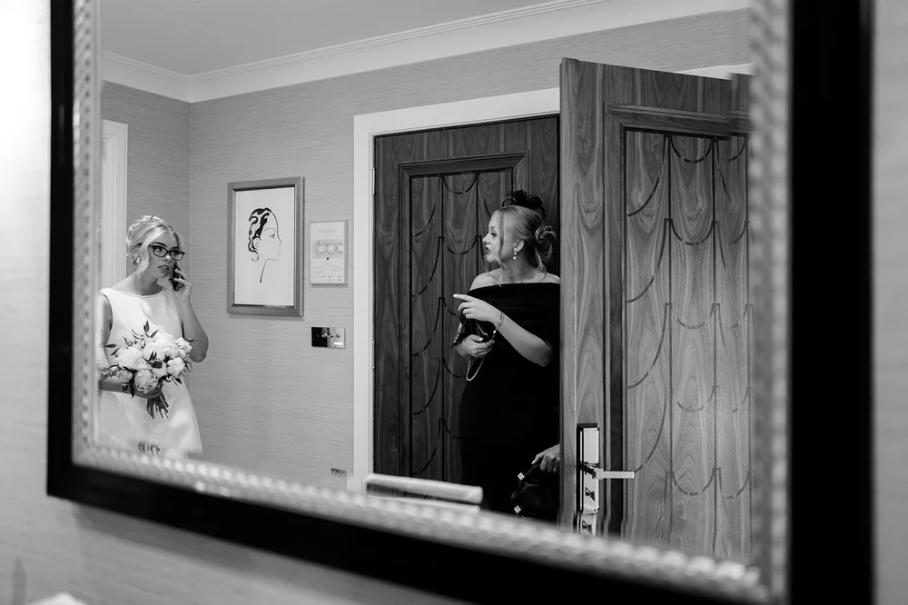 Black and white photograph of Charley reflected in the mirror during preparations