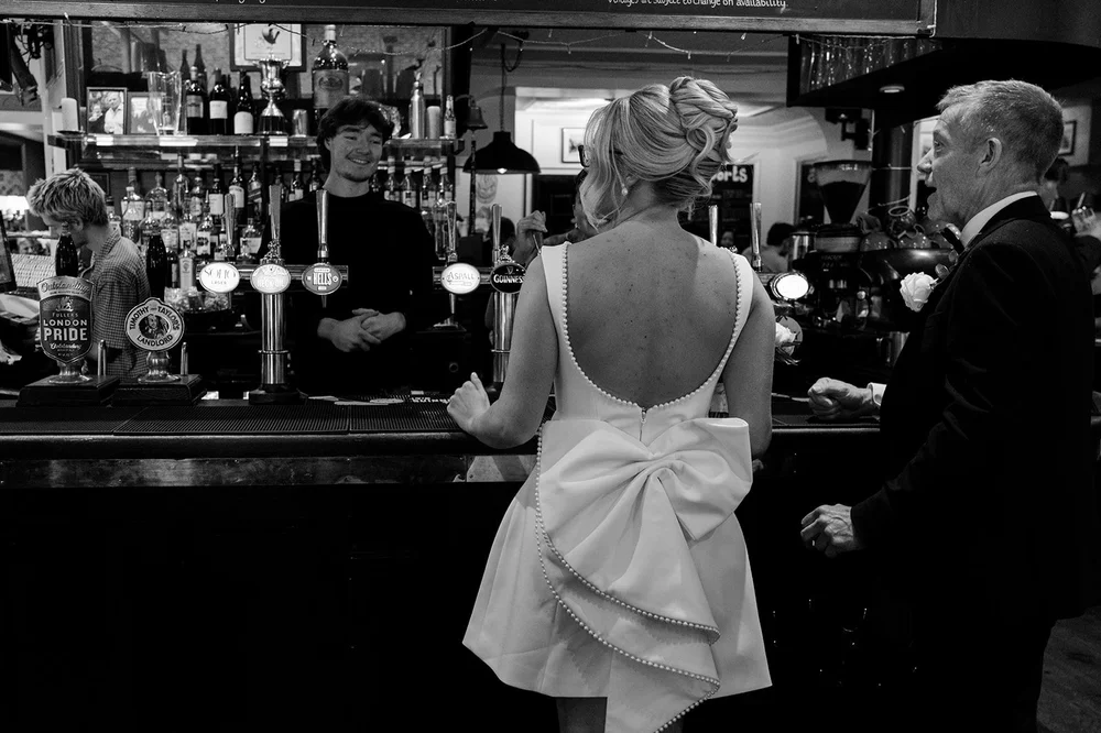 Charley at the bar before the ceremony, photographed from behind
