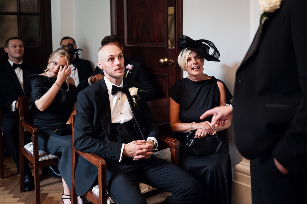 Guests with drinks waiting for the ceremony at Chelsea Old Town Hall