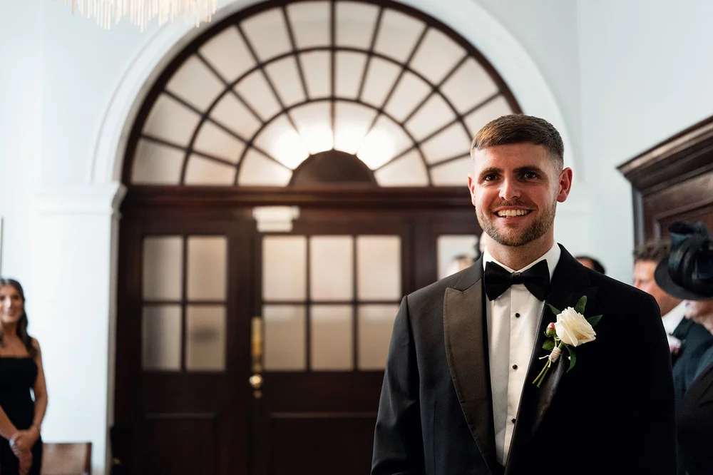 Joe waiting beneath the arched window in the Rossetti Room at Chelsea Old Town Hall