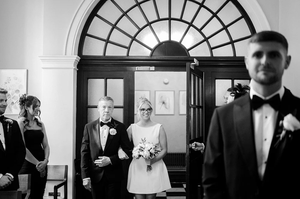 Black and white photograph of Charley walking in to the Rossetti Room