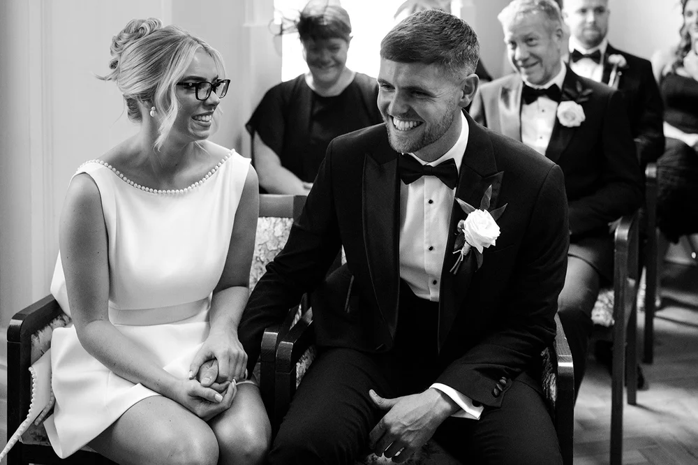 Black and white photograph of Charley and Joe at the registrar&rsquo;s table