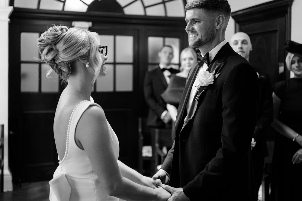 Black and white photograph of Charley and Joe exchanging vows