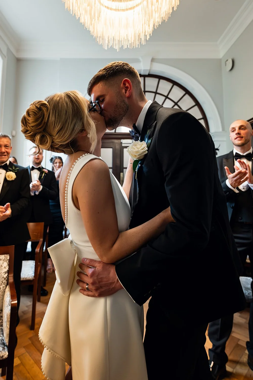 Charley and Joe embracing among their guests after the ceremony