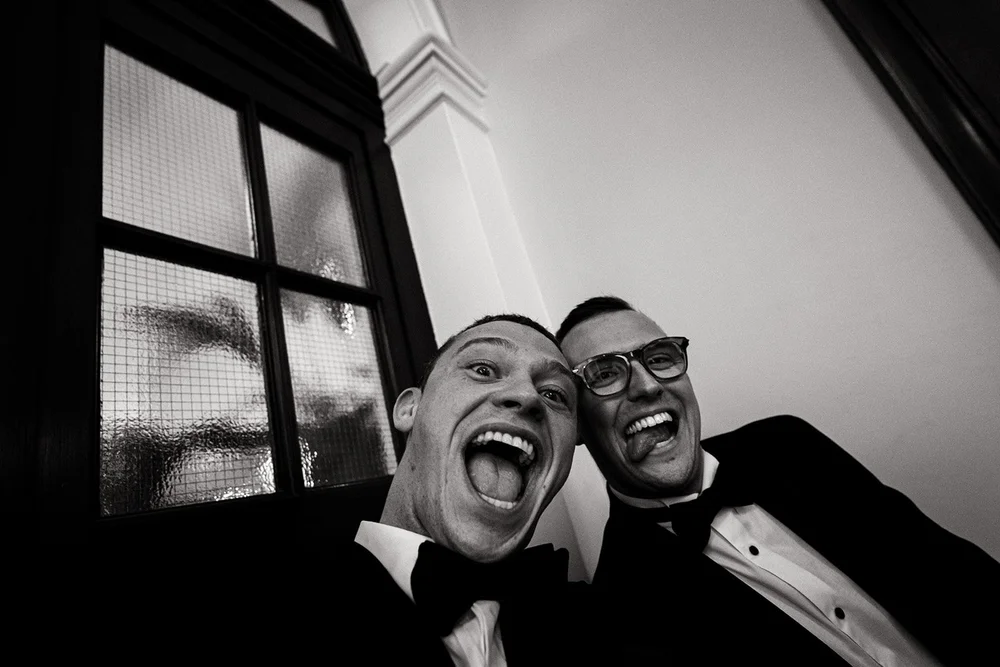 Black and white photograph of two guests laughing during the ceremony