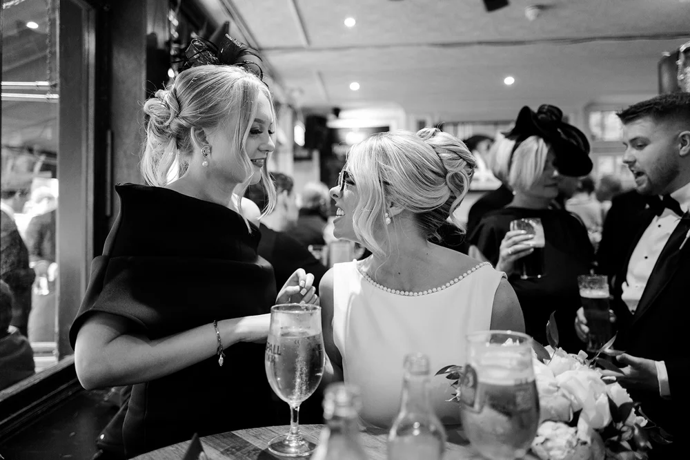 Black and white photograph of guests celebrating after the ceremony