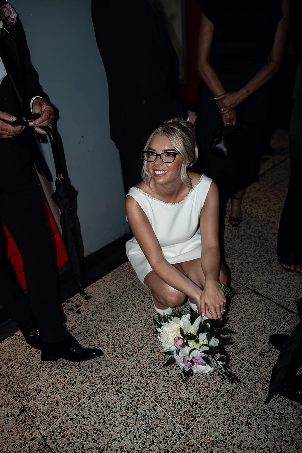 Charley sitting on the floor of the tube carriage with her bouquet