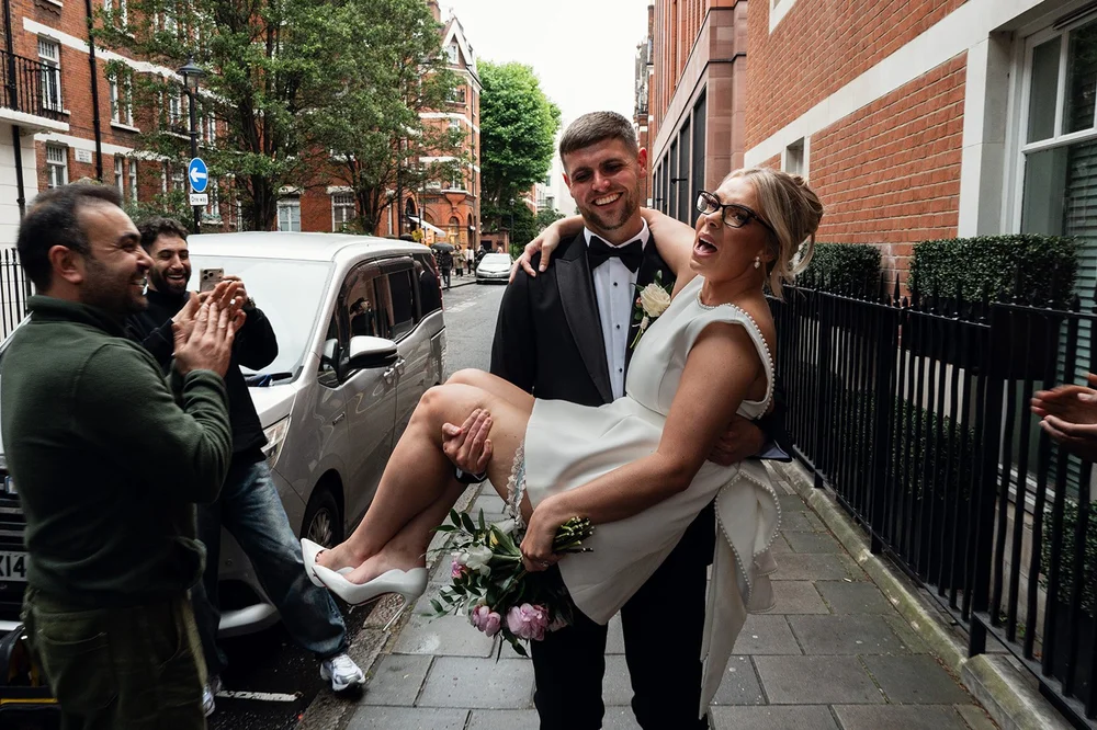 Joe carrying Charley through the street back towards Claridge&rsquo;s