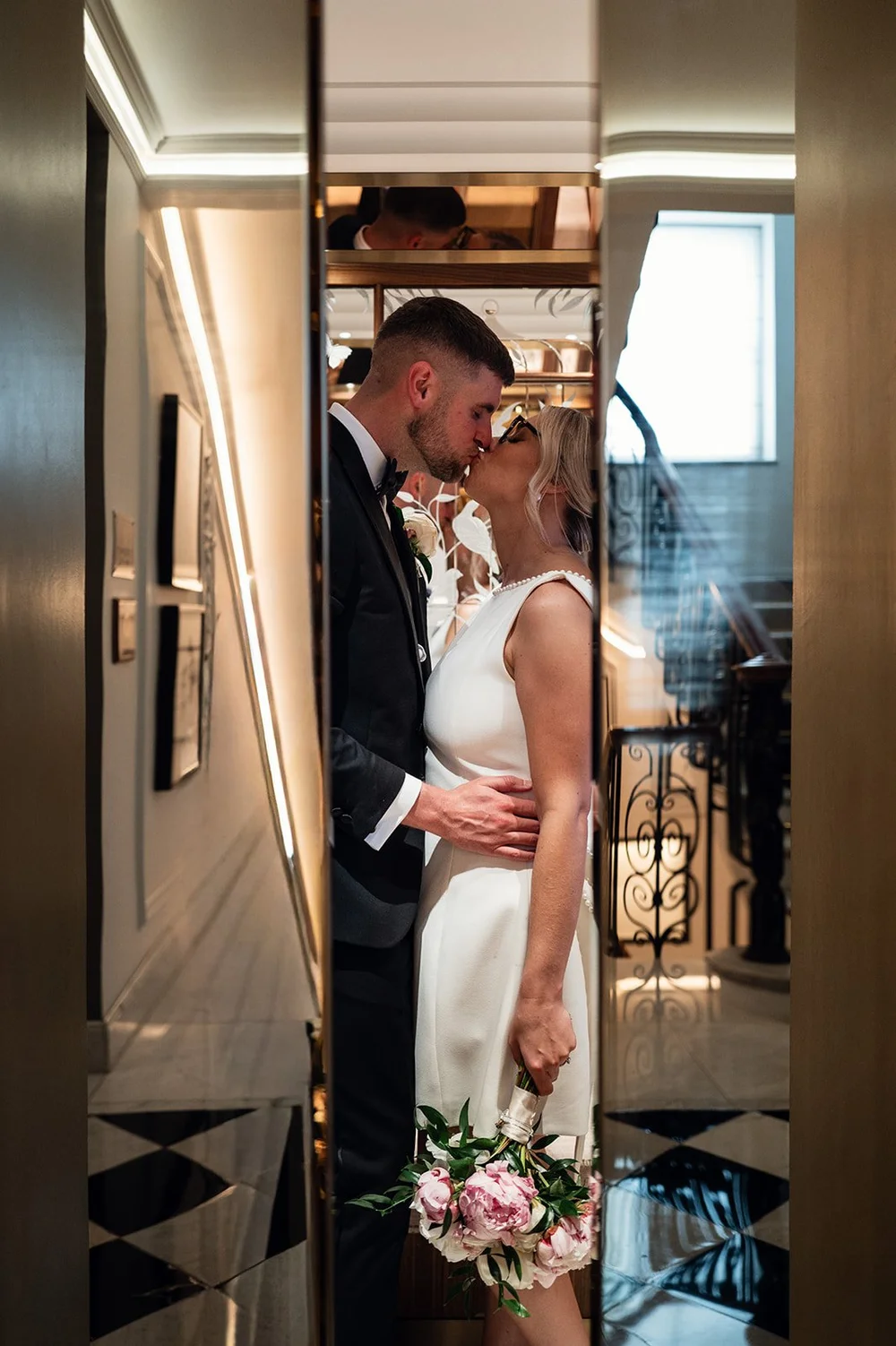 Charley and Joe kissing in the corridor at Claridge&rsquo;s at the end of the day