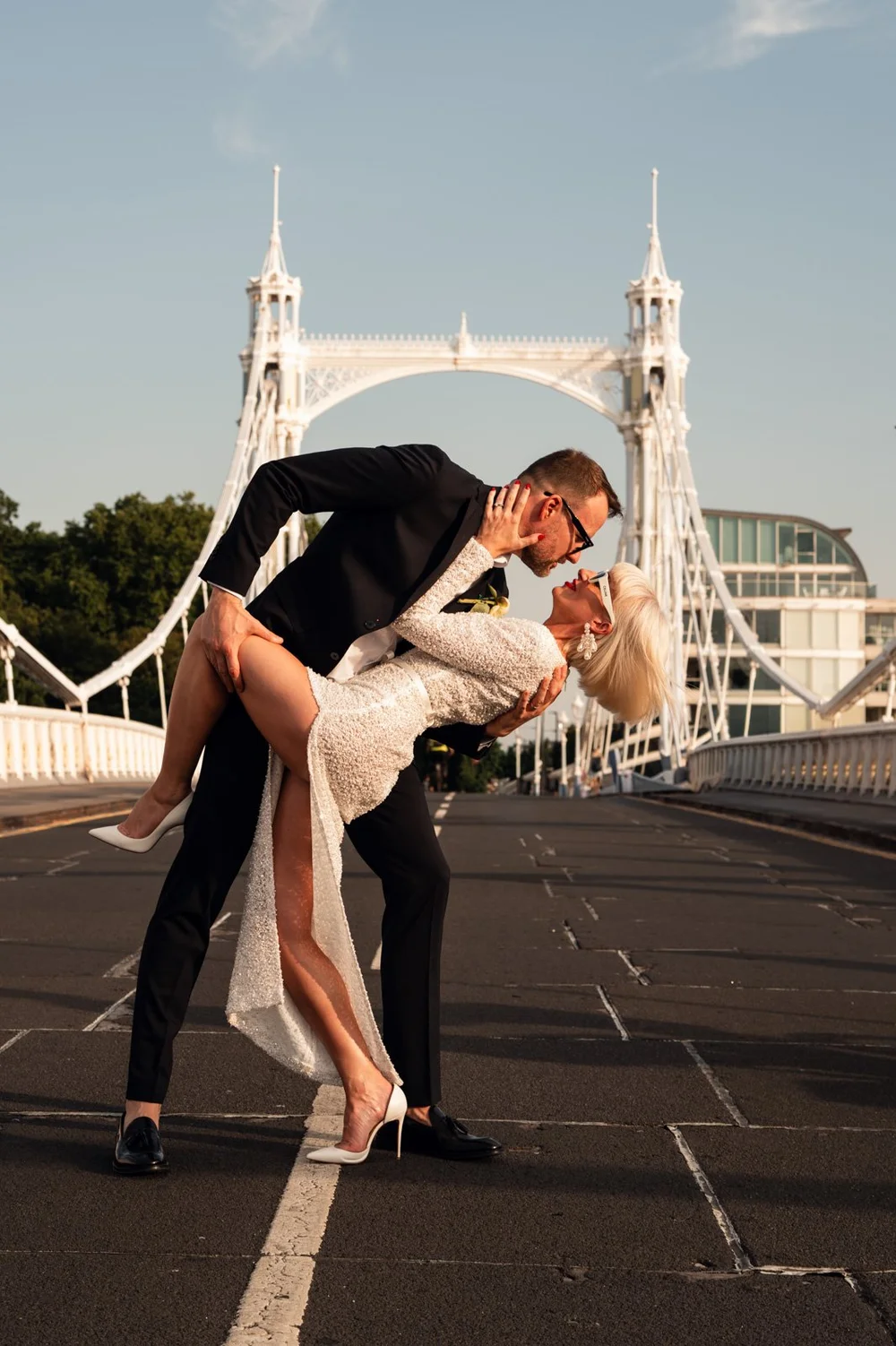 Elisa and Greg dancing on the bridge at golden hour between Chelsea Old Town Hall and Brunswick House