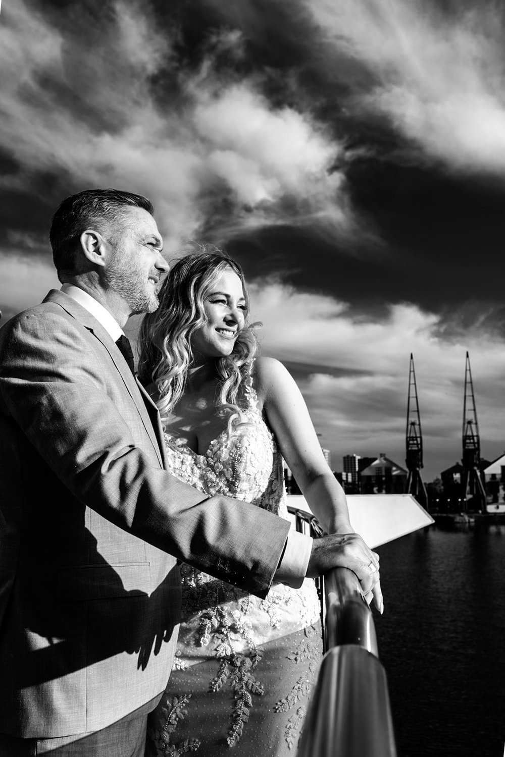 Bride and groom on the South Bank with The Shard and dramatic clouds behind them