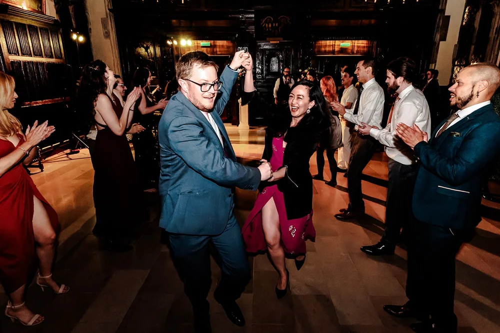 Groom dancing in the middle of a clapping circle of guests