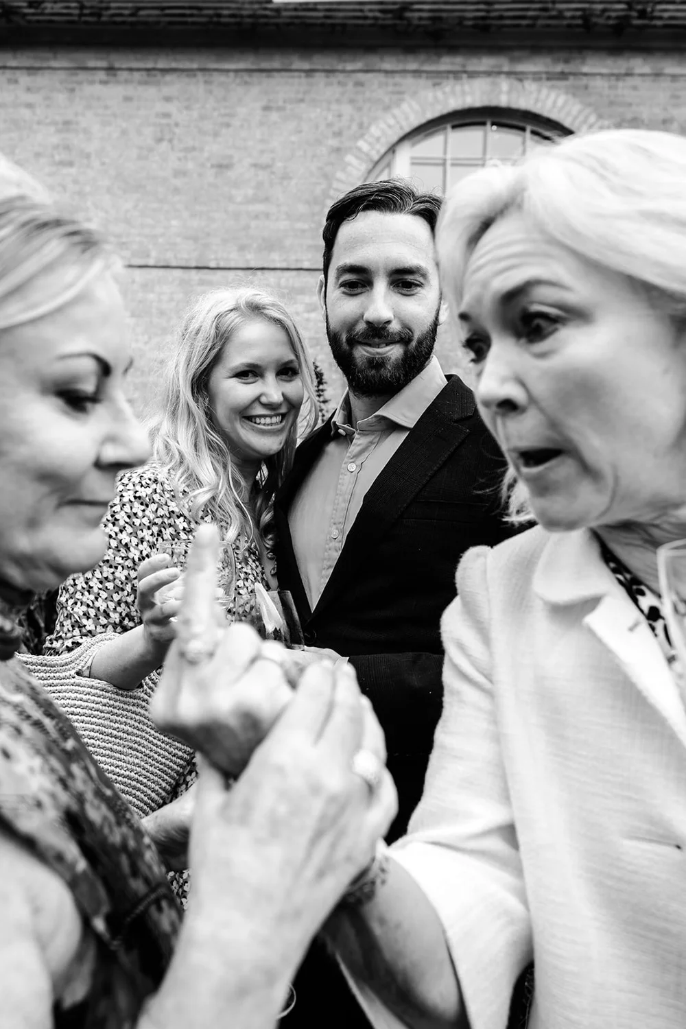 Guests crowding in together for a photograph, laughing