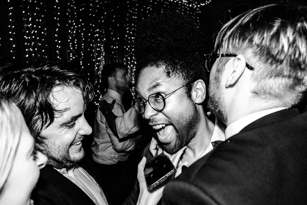 Guests singing together under fairy lights