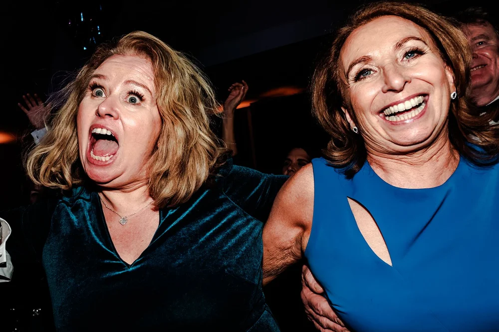 Two guests laughing on the dance floor