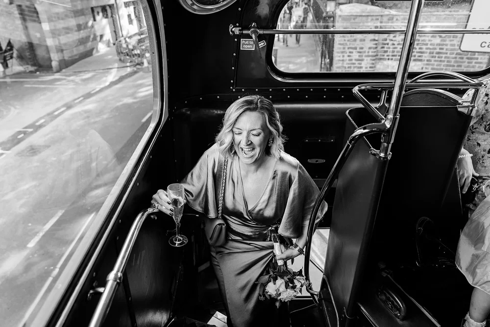 A guest riding a vintage bus between the ceremony and the reception