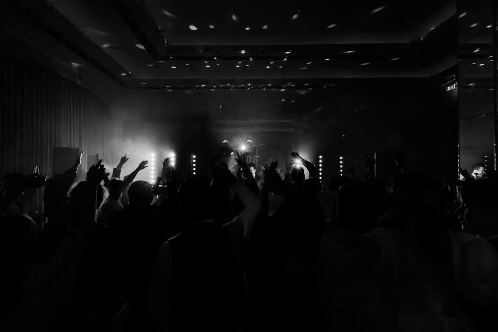 The dance floor in near darkness at the end of the night